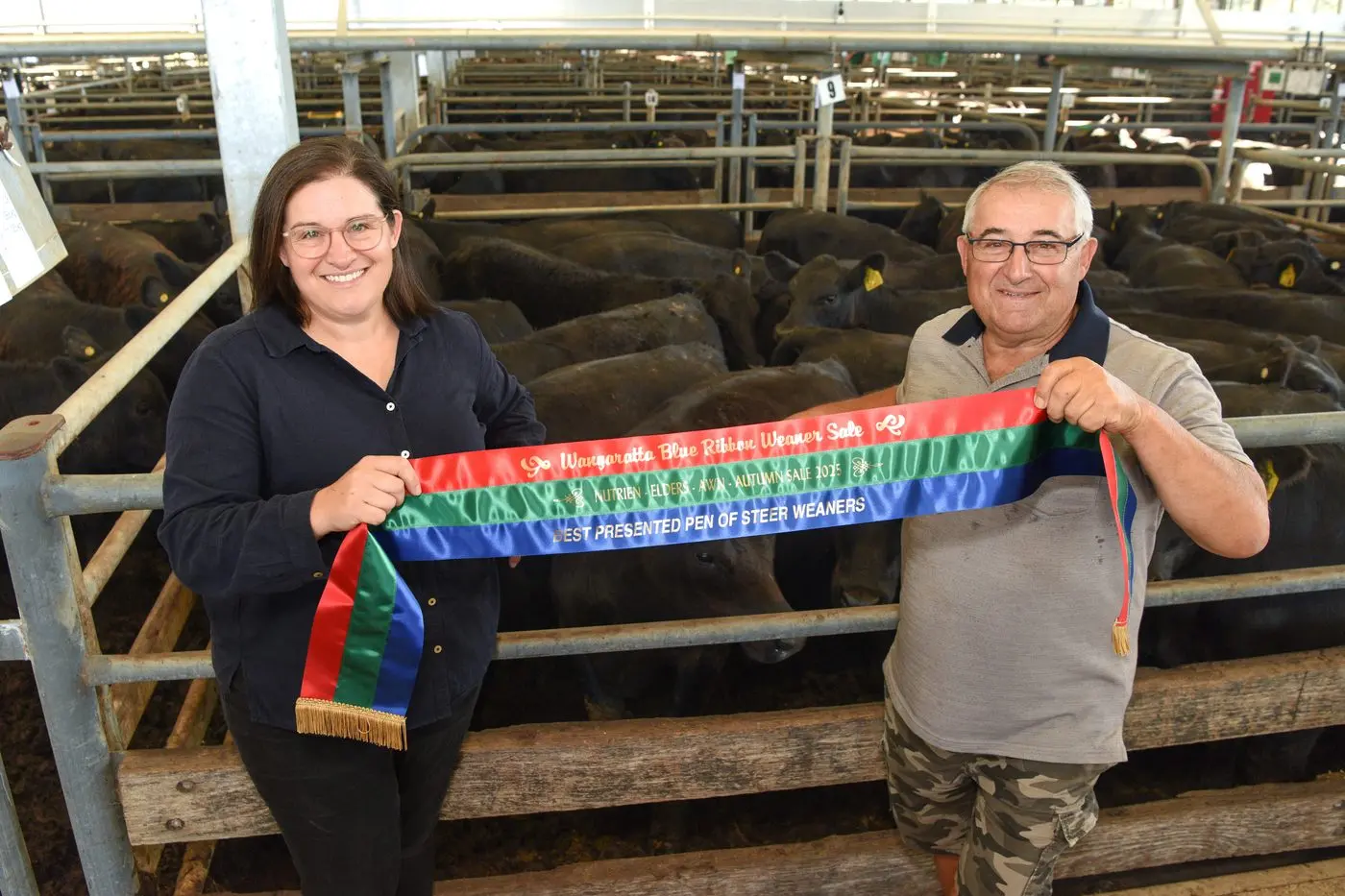 PROUD AS PUNCH: Laceby cattle producers Phillip and Megan Callus show off their winning ribbon. PHOTOS: Kurt Hickling. 