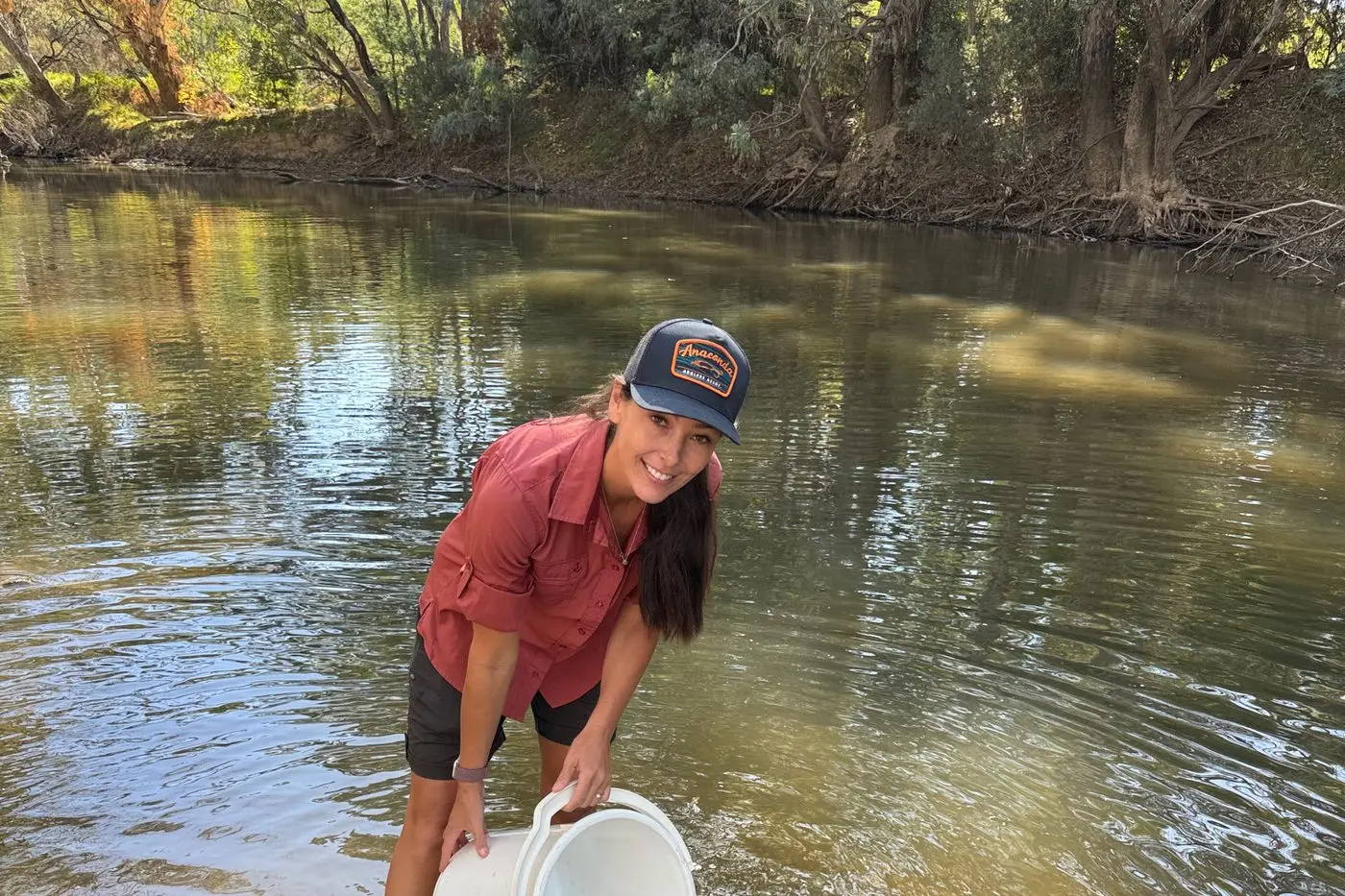 NEW HOME: Wangaratta Landcare and Sustainability Inc (WLS) volunteer Kate Norman helped release 500 freshwater native catfish in the Ovens River at the Templeton Street boat ramp in Wangaratta last week.