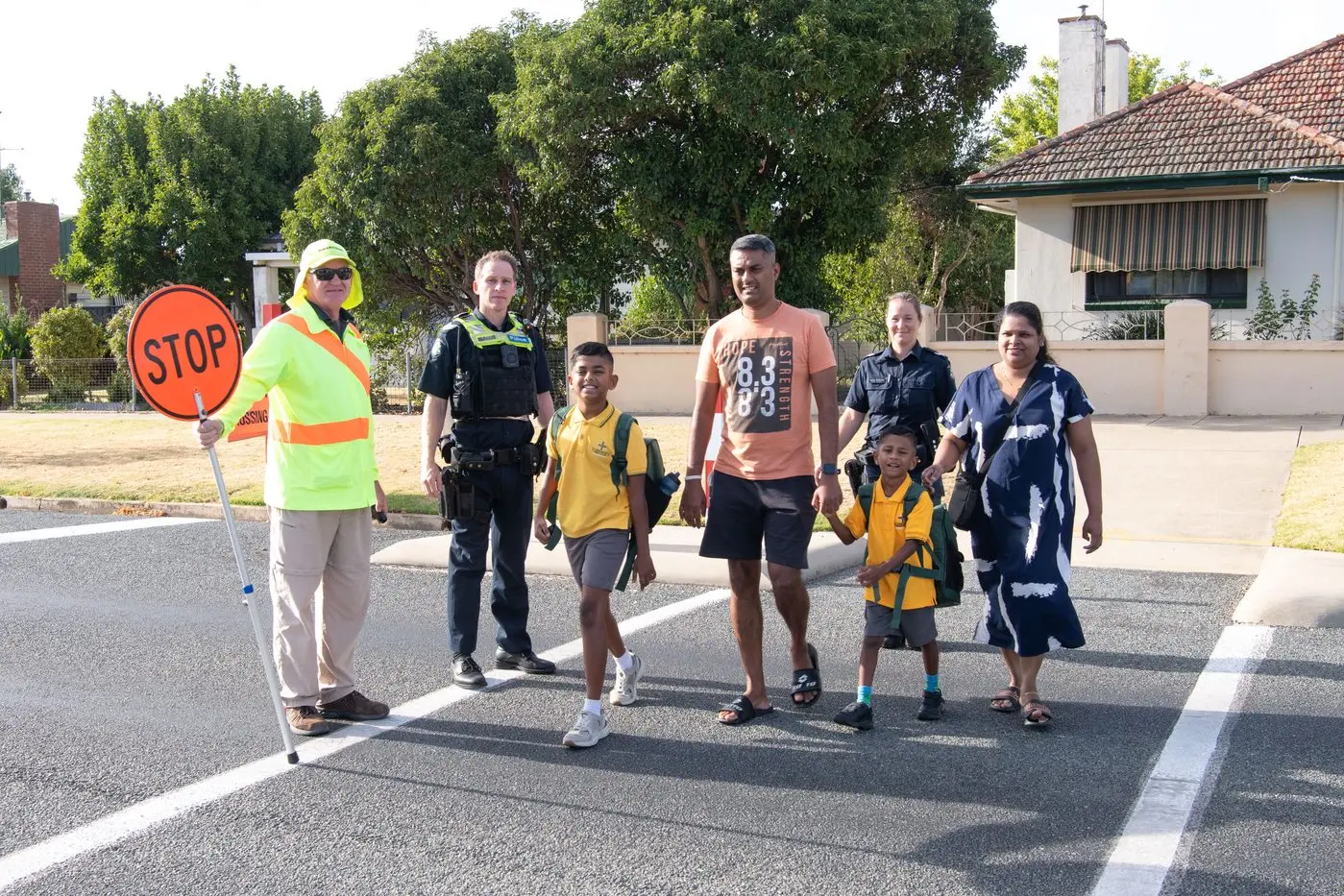 WALK WITH CARE: School crossing supervisor Graham Spence and Wangaratta Police\\'s Sergeant Shaun Hillier and Senior Constable Hayley McDonald help usher the Joseph family of Ruhan, Joseph, Rohith and Chithra across Williams Road to St Bernard\\'s Primary School. PHOTOS: Kurt Hickling