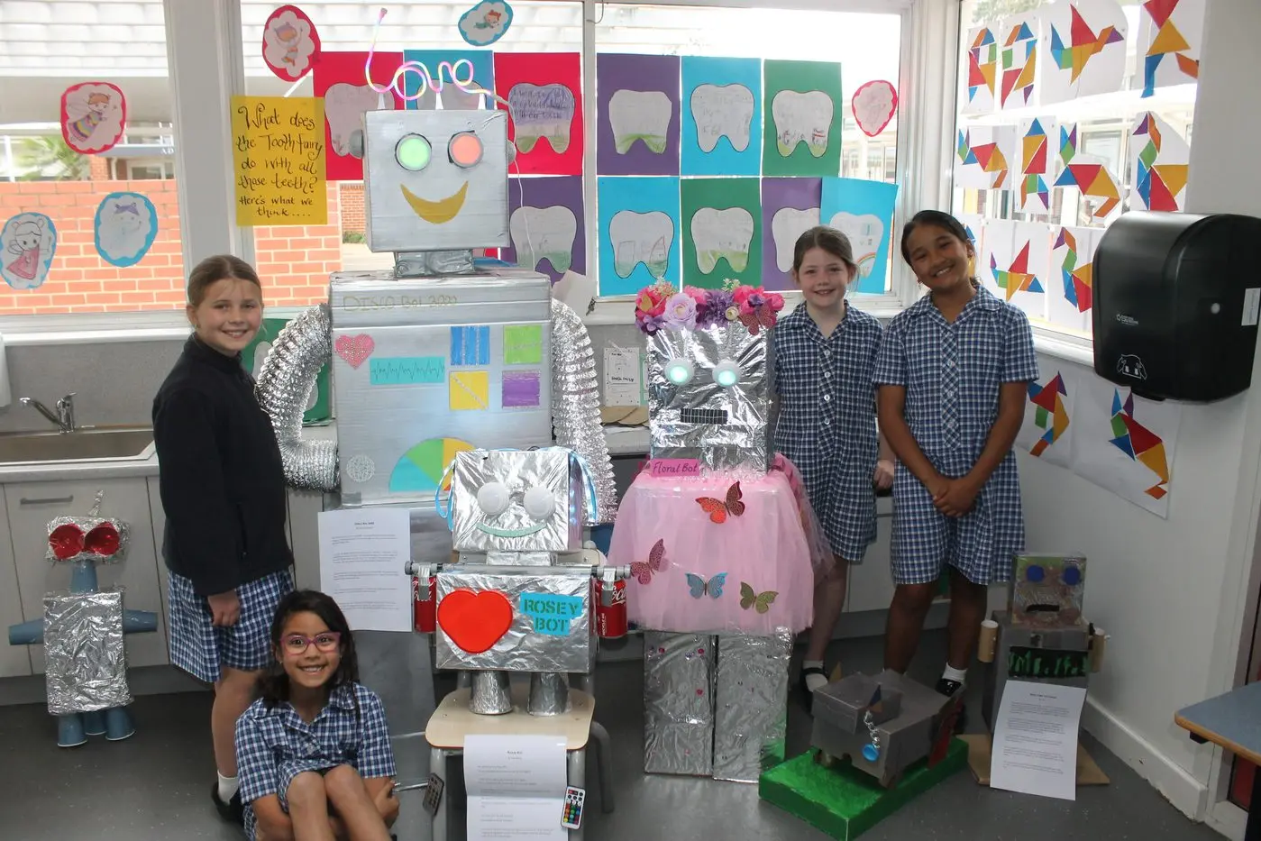 SCIENTIFIC STYLE: St Mary\\'s year 3 + 4 students (from left) Sophie Kimball with her creation Disco Bot 3000, Anna Barry with Rosey Bot, Matilda McKeone with Floral Bot and Isabel Law with the Bark-O-Bot and Owner, showcased the wide range of innovation required to construct their creations. PHOTOS: Phoebe Morgan