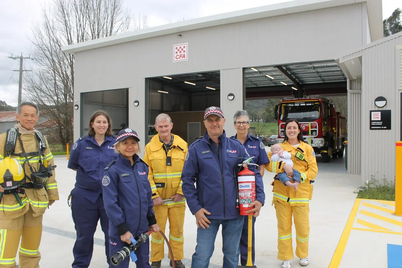 JOIN US: Porepunkah CFA members (from left) Lawrence Wong, Sarah Clapperton, Renee Lee, Ed Rozitis, Captain Mick Dalbosco, Colleen Ellis and Kiah Ross with \\'future captain\\' Tucker, are inviting the community to tour their upgraded station this Sunday and get ready for the fire season. PHOTO: Phoebe Morgan