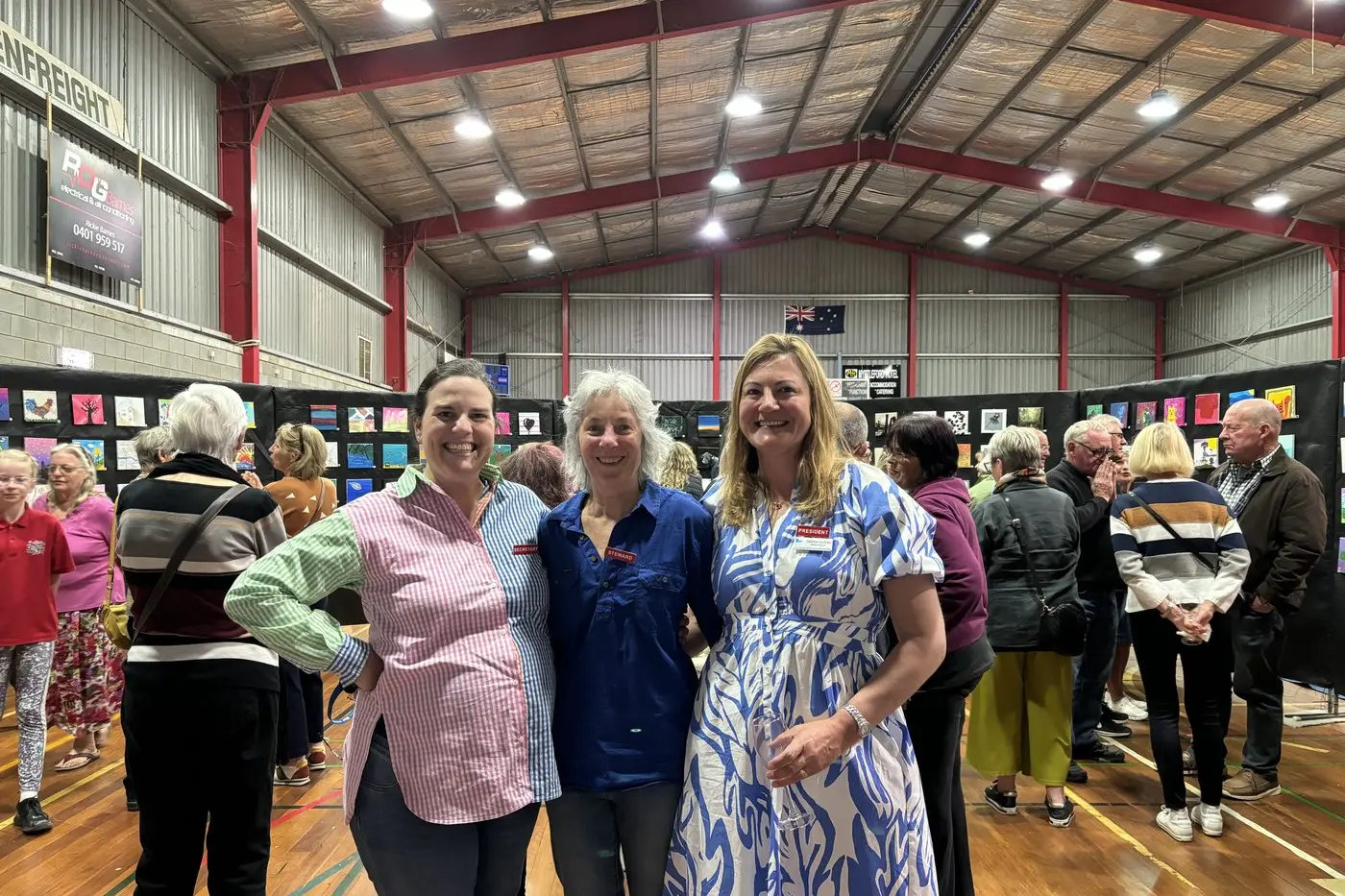 LOCAL LIFE MEETS THE CANVAS: Myrtleford Show committee secretary Amy Kirk, horticulture steward Lorraine Hughes and president Deb Geddes celebrated last year\\'s artists ahead of show day. PHOTO: Melanie Dymond