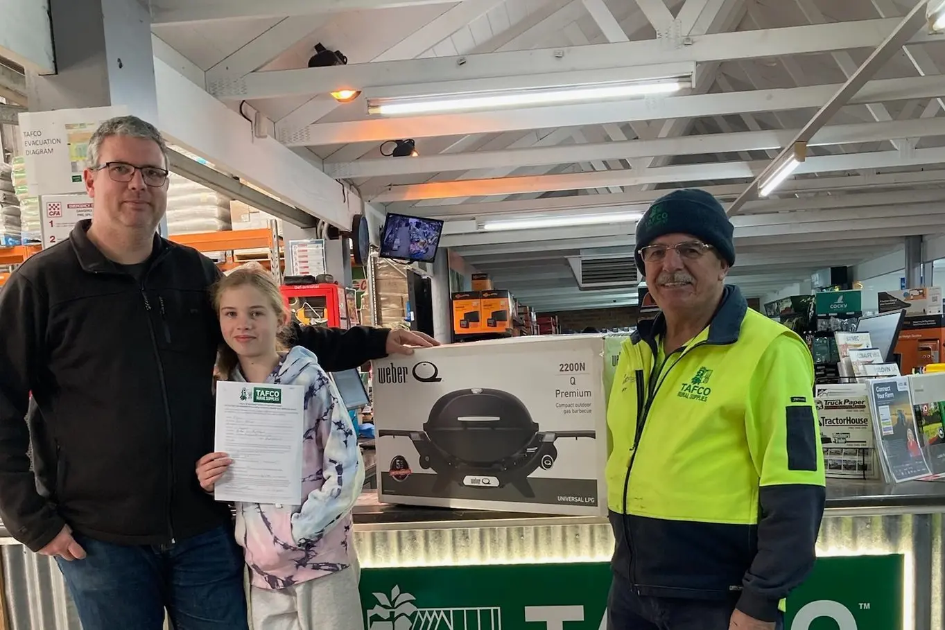 JOIN THE CLUB: TAFCO\\'s 1000th member, Shane McAlpine (left) with his daughter Isabelle, received a \\'Weber Q\\' by staff member Tony Vescio, to celebrate being welcomed to the local co-operative. PHOTO: TAFCO Myrtleford.