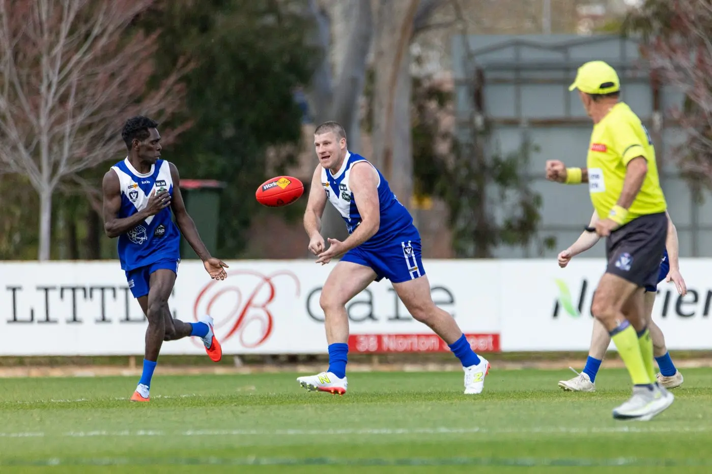 OVERLAP RUN: Dylan Bursill gives the handball to Marcus Kinthari.