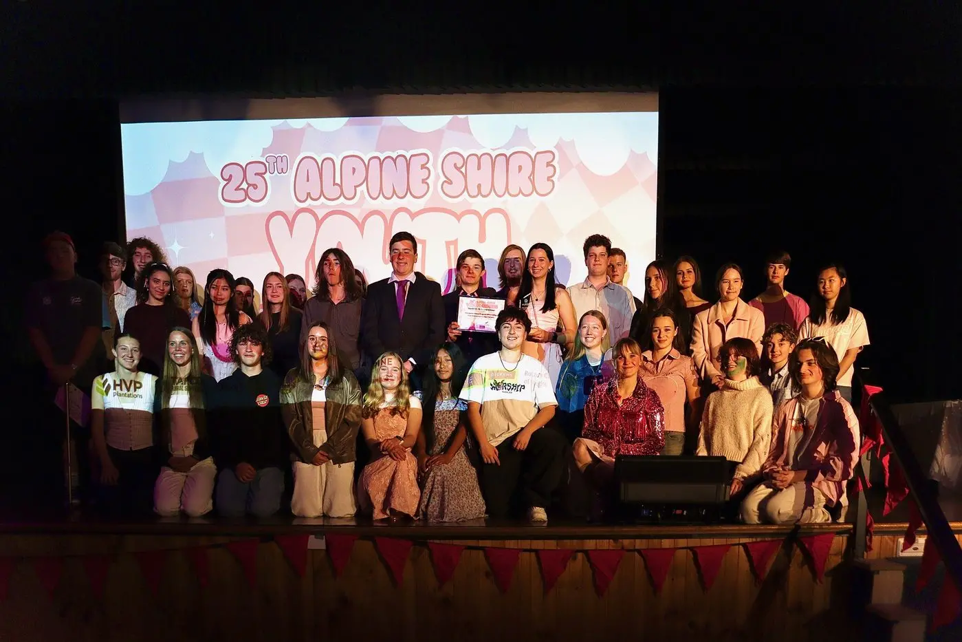 STANDING ROOM ONLY: There was barely any room left on the stage as this year\\'s Alpine Shire Youth Award recipients and committee members assembled. Pictured are (back, from left) Harry Dudley, Ethan Jenkins, Geordie McEwan, Sharnea Hall-Bidois, Teagan Brown, Sofia Mendoza, Sierra Davies, Lauree Duncan, Lucy Chester, George Milligan, Lilly Bennett, Connor McEwan, Wade Pronk, Jack Byrne, Amelia Midson, Thomas Costenaro, Connor Taylor, Teagan Chirstie, Evelyn Niedzwiedzki, Chalisa (Natalie) Borrell, Julian Kitchen, Mo Han Wang, (front, from left) Lily Boyer, Jade Hazeldine, Tayler Sacco, Helina Murphy, Emma Pitman, Sein Pai Kihlo, Sienna Alam, Emily Macklan, Elkie Timbs, Kirsten McLennan, Lizzie Day, Oscar Ford and Patrick Day were applauded by the community for their achievements. PHOTO: Renae Blake