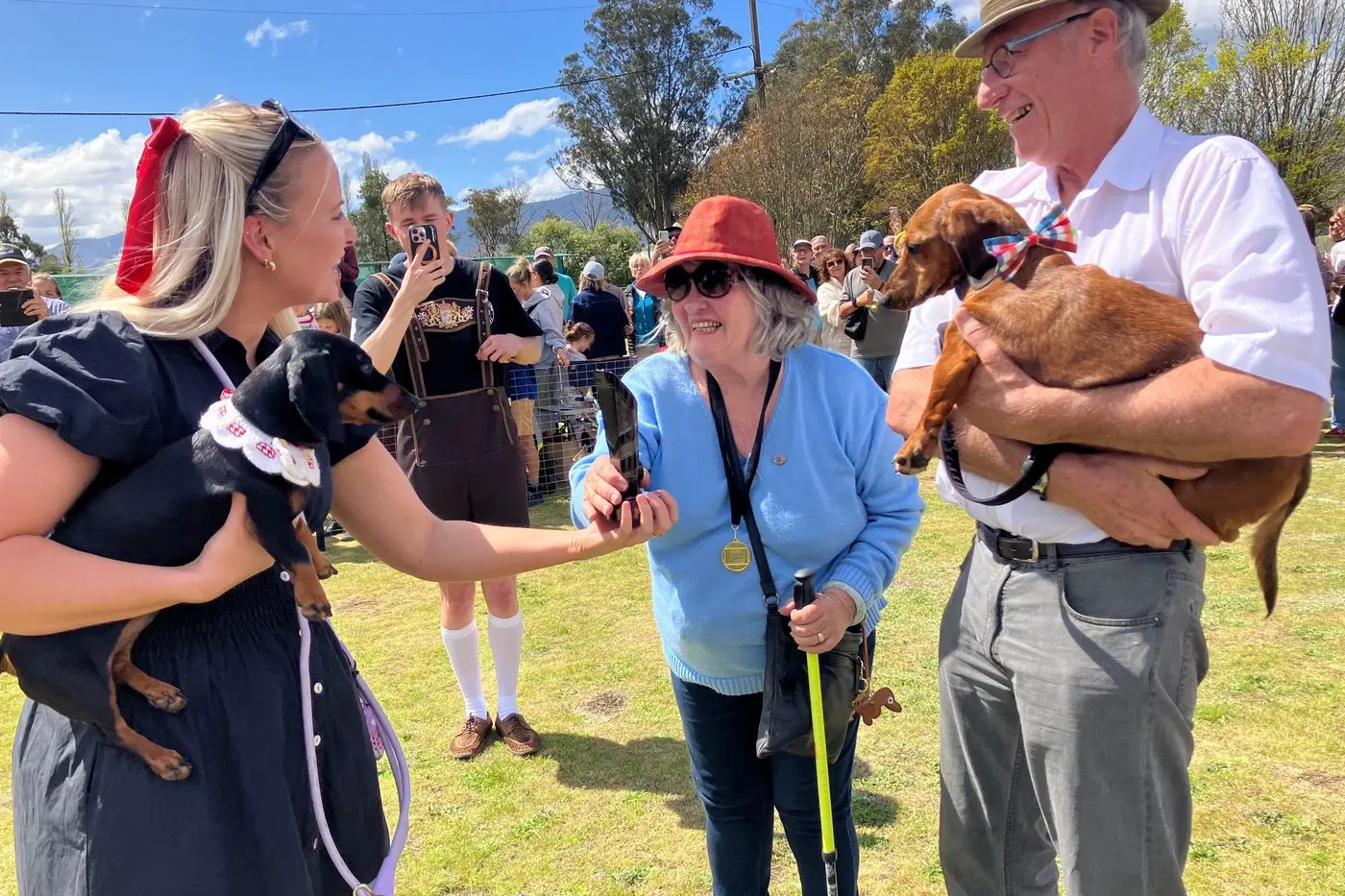 DOGS\\' DELIGHTFUL DASH: The Dachshund Derby and Oktoberfest celebrations drew a big crowd to Mountain Monk Brewers in Mt Beauty last Saturday. Special guest, Valerie the Dachshund and her owner Georgia Gardner (left) had the honour of presenting to the race winner, Darcy, and his owners Lauretta and Stewart Strong with the coveted cup.