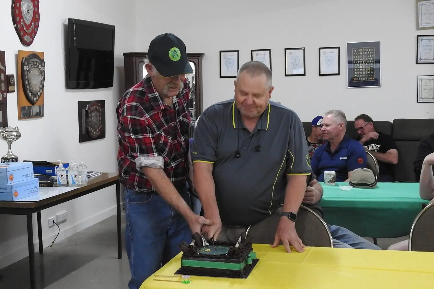 NEW LIFE MEMBERS: Tony Rohrlach and Paul McKendrick cut the 70th birthday cake to celebrate the Euroa Clay Target Club\\u2019s milestone anniversary.