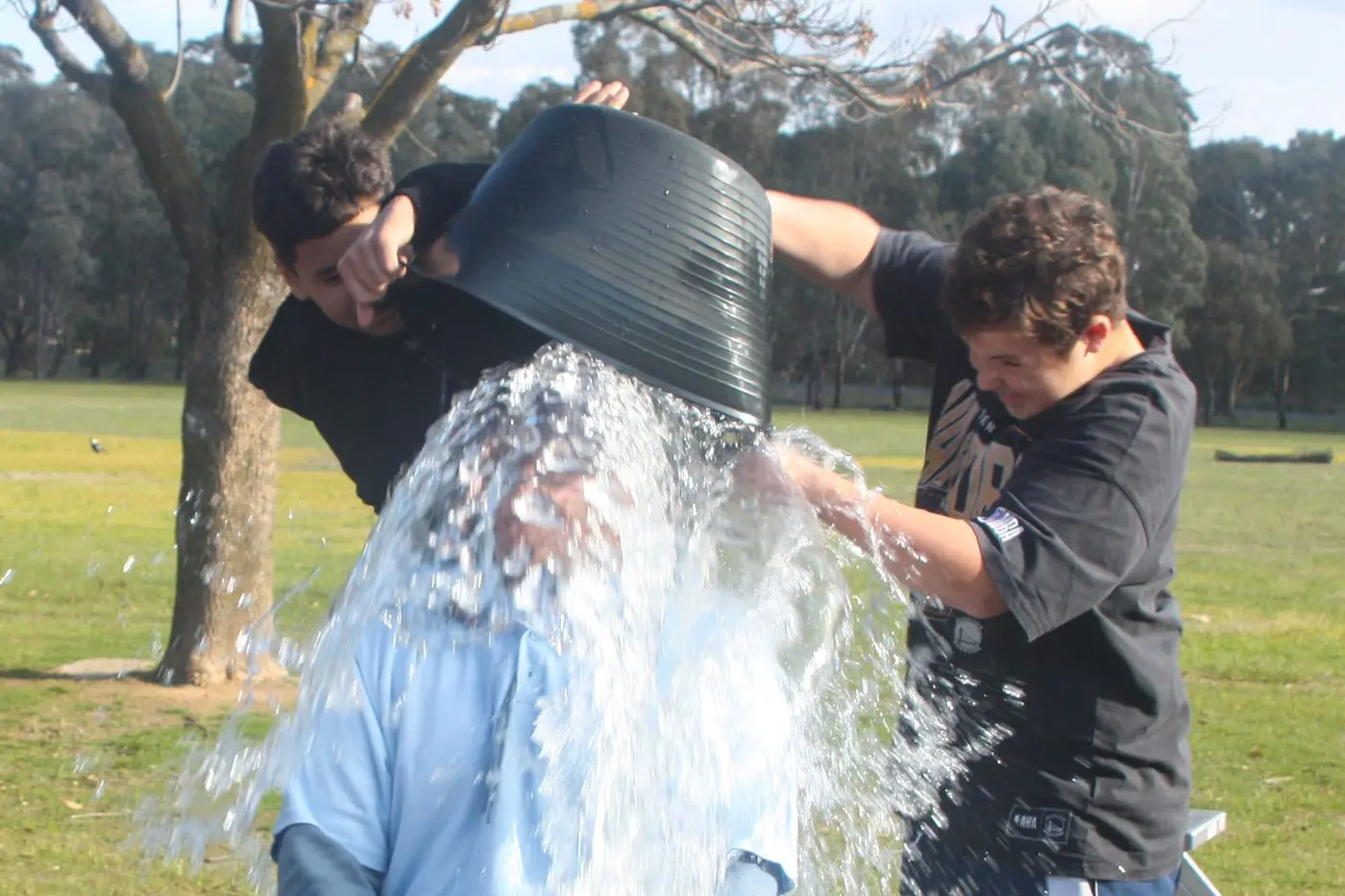 TAKE THAT: Teacher Will Lawson is bucketed by Jason Hokianga and Mason Morunga. PHOTOS: Lynnda Heard
