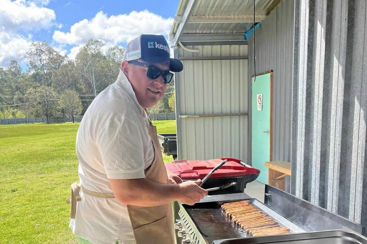 ON THE GRILL: Helpers fuel the fun with a sizzling barbecue for all.