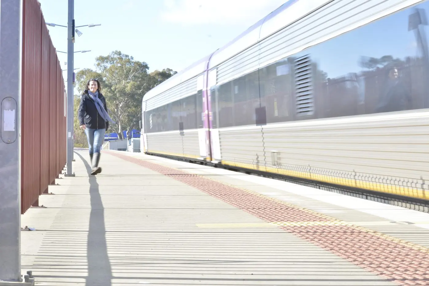 CLOSE TO THE EDGE: A pedestrian takes the new detour to cross the railway line via the station platform. PHOTO: Andy Wilson