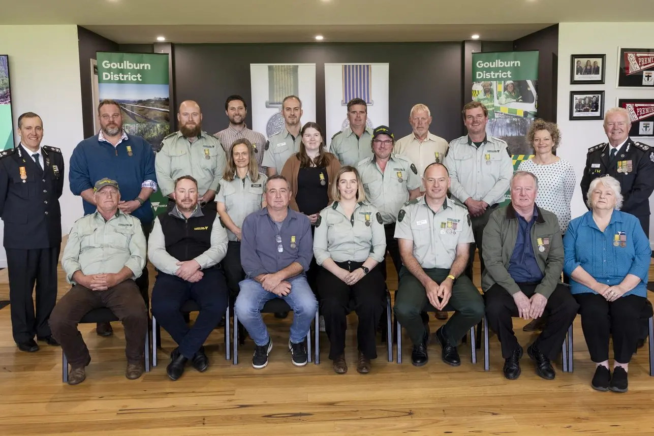 LOCALS RECOGNISED: FFMVic Mansfield National Emergency Medal recipients (from left, front) Rodney Blake, Justin Berry, Geoff Hickson, Prue Abela, Scott Edwards, Phil Savage and  Brigitte Wentworth, with (from left, back)  Aaron Kennedy (Deputy Chief Fire Officer, Hume), Patrick Meehan, Josh Williamson, Catherine Spencer, Tim Berenyi, Brendan Purcell, Jess Downie, Chris Mitchell, Tom Borstner, David Hurley, Jim Winters, Kelly Crosthwaite (Deputy Secretary, Bushfire and Forest Services) and Chris Hardman (Chief Fire Officer).