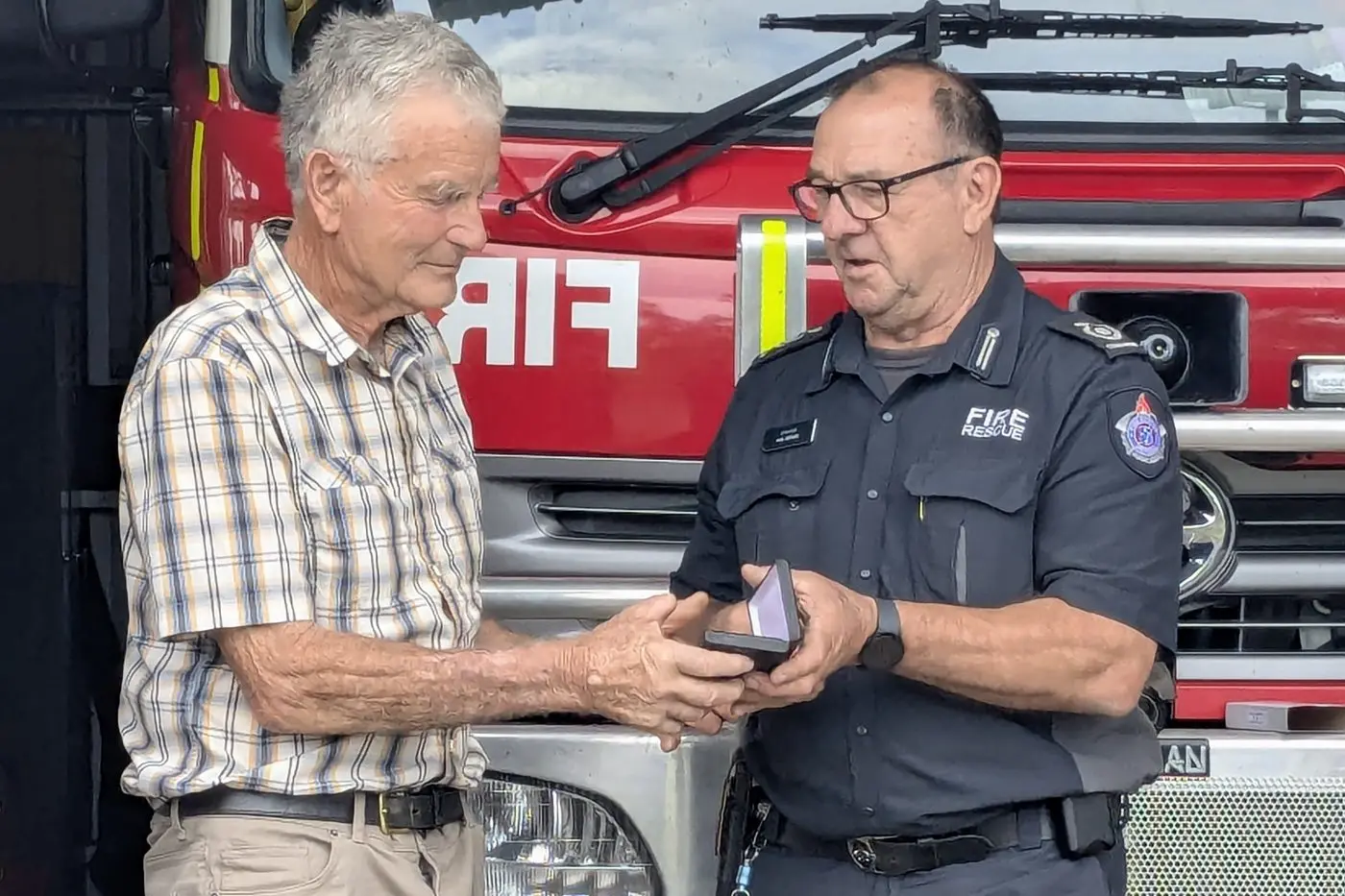 HONOURED: Commander Paul Scragg presents the Life Member medal to former Barjarg Brigade Captain Chris Bennetts