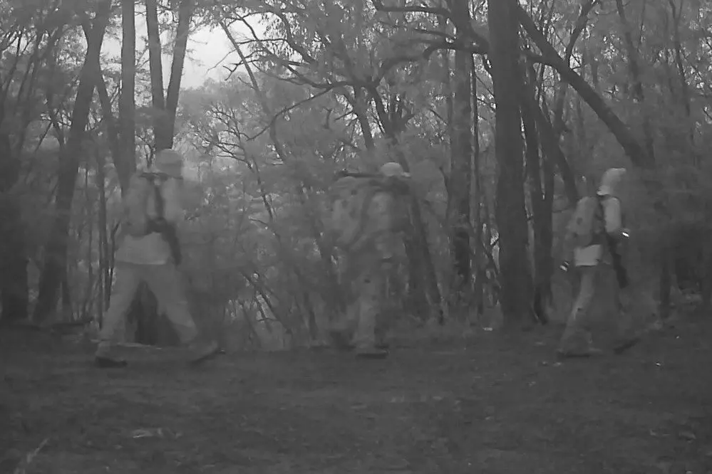 ON CAMERA: Trail cameras captured three people carrying hunting equipment on a Howqua property on Friday 18 July.
