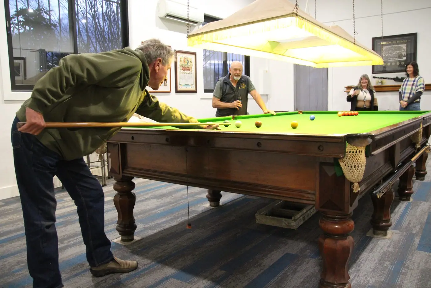 GAME ON: President Ken Thompson challenges RSL member Matt Leggett for a game of snooker while he looks on with members Trish Thompson (left) and Fiona Bolitho in the newly revamped space. PHOTOS: Lynn Elder