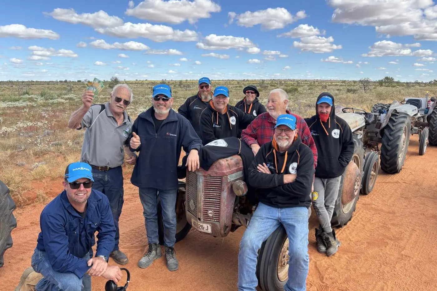 ON A MISSION: The Parkes Tractor Trekkers with John Montgomery who took a detour home from Cape York to meet up with the trekkers. John is proudly holding up his $500 donation to the cause. PHOTOS: Parkes Tractor Trekkers Facebook page