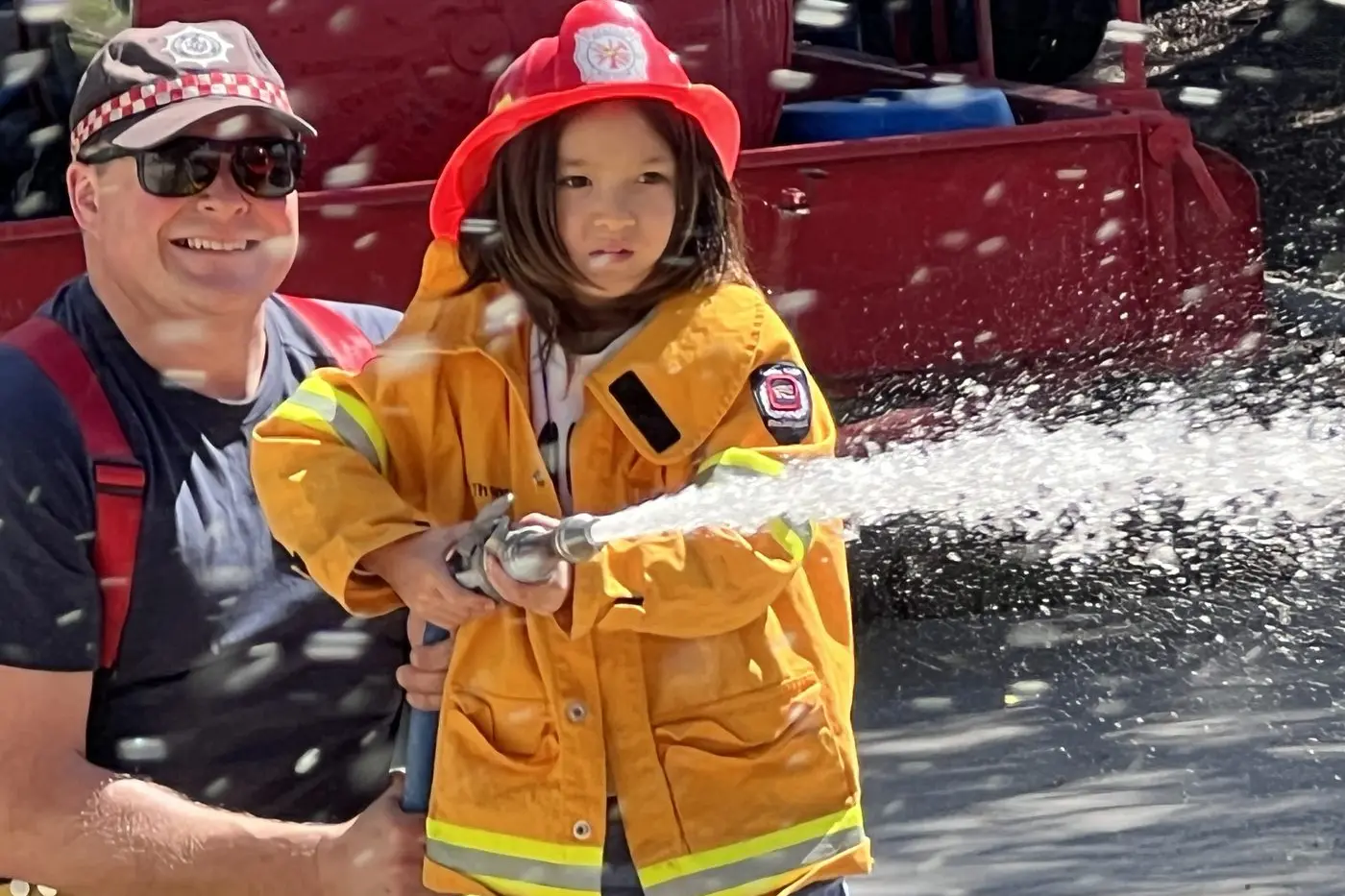 LEARNING HANDY SKILLS: South Wangaratta CFA second lieutenant Matt Thomas was helping six-year-old Jack Wright of Wangaratta gets some hands-on experience at the brigade\\'s Get Fire Ready event on Saturday. PHOTO: Jeff Zeuschner