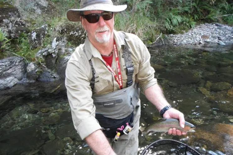 NICE CATCH: Wangaratta Fly Fishing Club president Bryan King with a lovely rainbow trout caught in a North East stream.