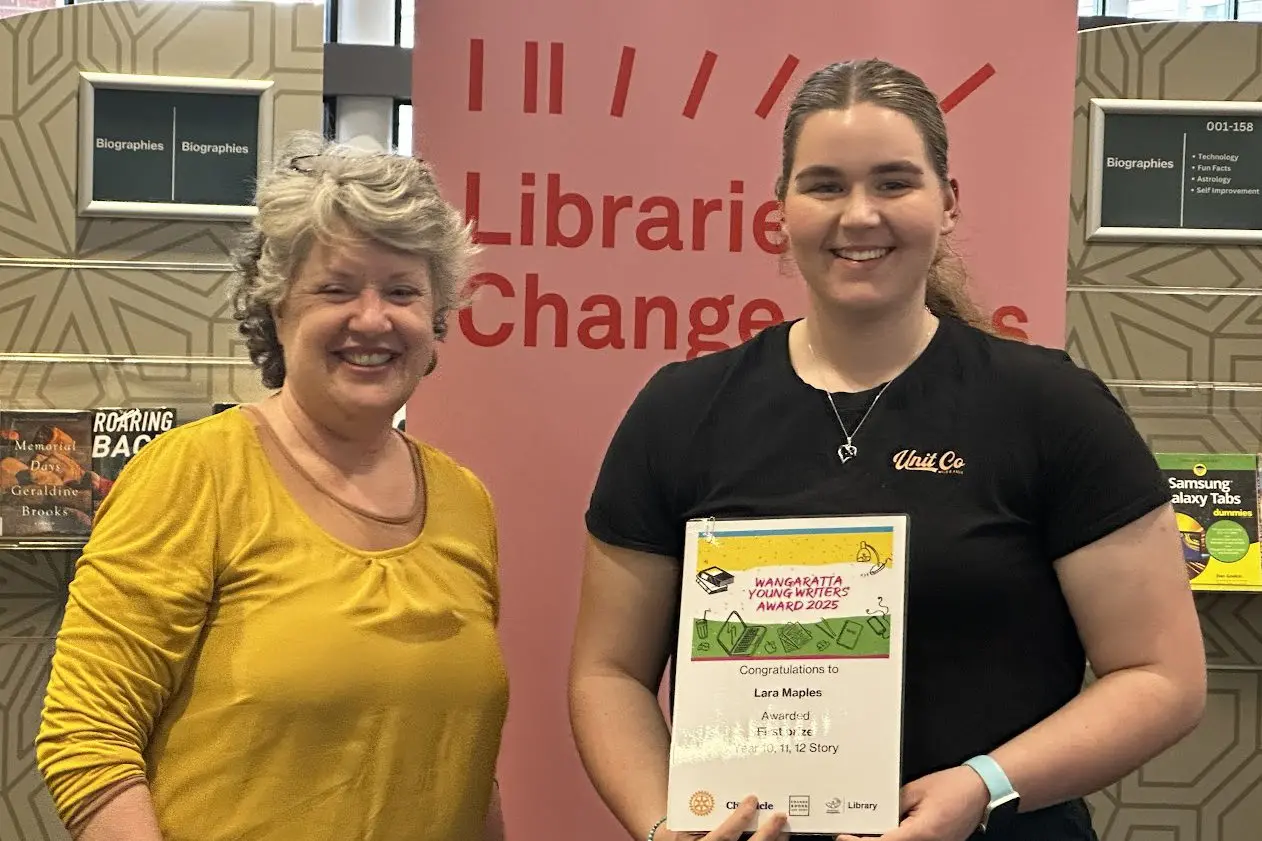 YOUNG WRITER: Liz Long from Edgars Books & News presents one of the winners, year 10/11/12 story category first placegetter Lara Maples, with her certificate during Thursday\\'s presentation.\\n
