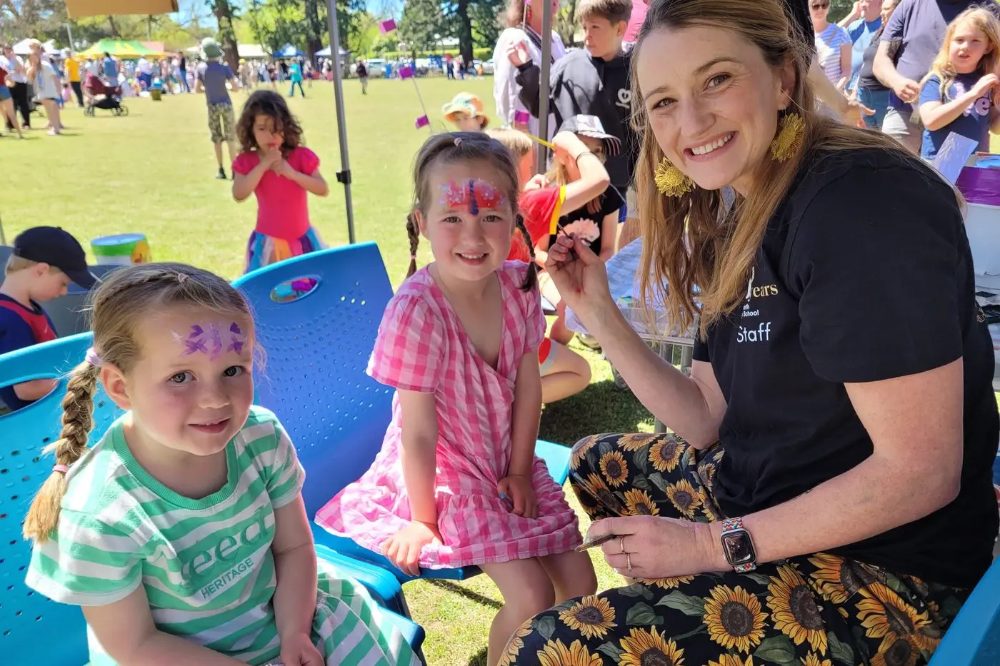 FUN: Four-year-old Eloise Mason (left) and her sister five-year-old Harriet had their faces painted by Beechworth Secondary College teacher Bethany James. PHOTOS: Coral Cooksley
