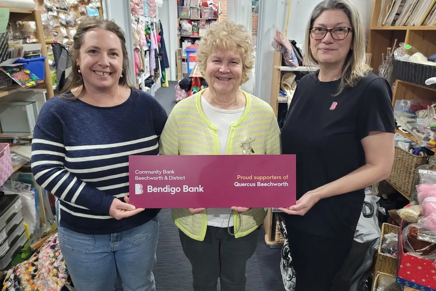 ALL SMILES: Quercus Beechworth operations coordinator Heather Jameson (left), volunteer Judi Neuman and customer services officer Emma McDonnell from Community Bank Beechworth & District (Bendigo Bank) at the Op Shop on Tuesday. PHOTO: Coral Cooksley