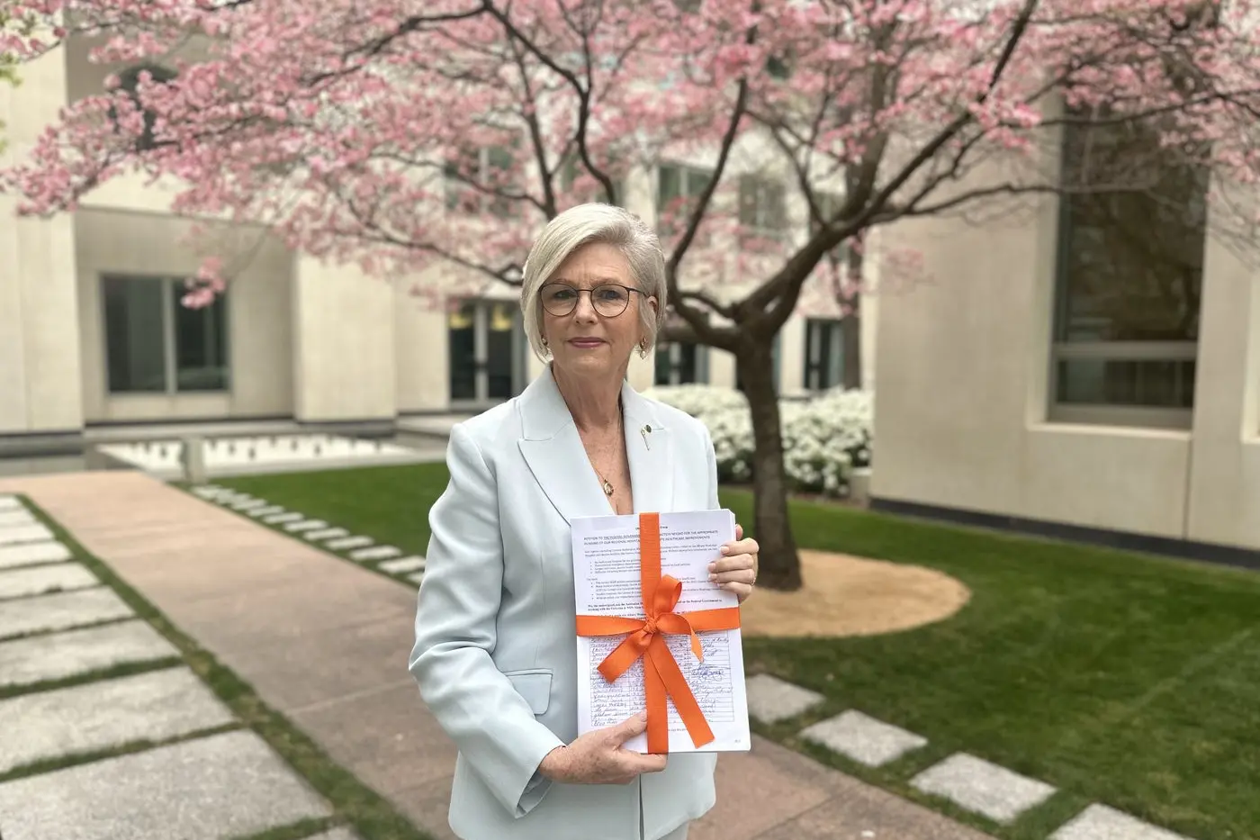 GIFT WRAPPED: Indi MP Helen Haines presented this petition signed by Corowa, Wahgunyah and Rutherglen residents calling for a fully funded, single-site hospital on the Border to federal parliament on Tuesday.