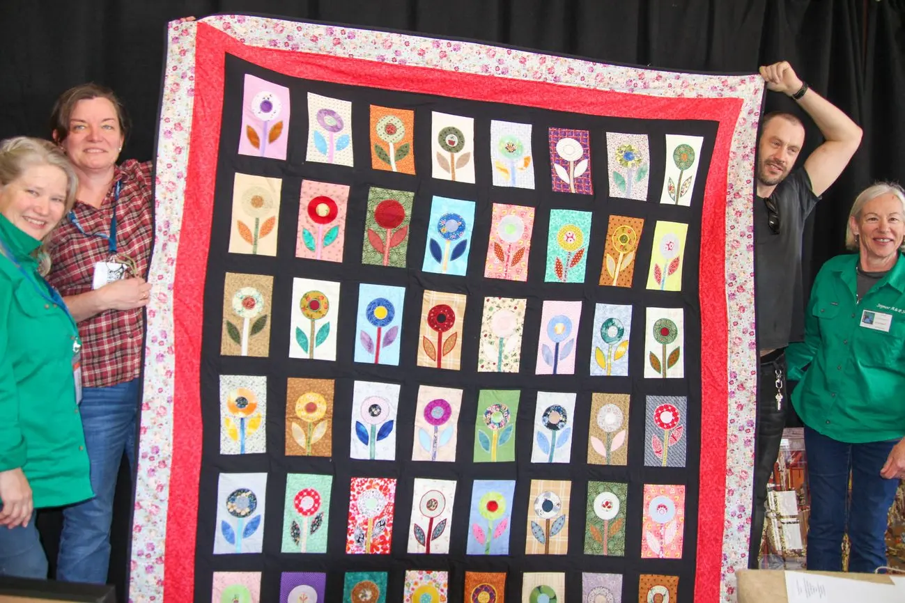 HANDCRAFTED: Holding the donated raffle prize of a quilt in the Seymour Show Craft Pavilion is Vice President Cherie Matthews (left), Anita Ryme steward, sponsor Tim Dyer and president Anne Davidson. PHOTO: Lynn Elder