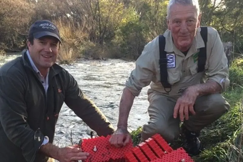 JORDAN/SCOTTY INCUBATORS: Mansfield Fly Fishers Club president Matt Byrne and Australian Trout Foundation president Terry George installing incubators in a local stream.