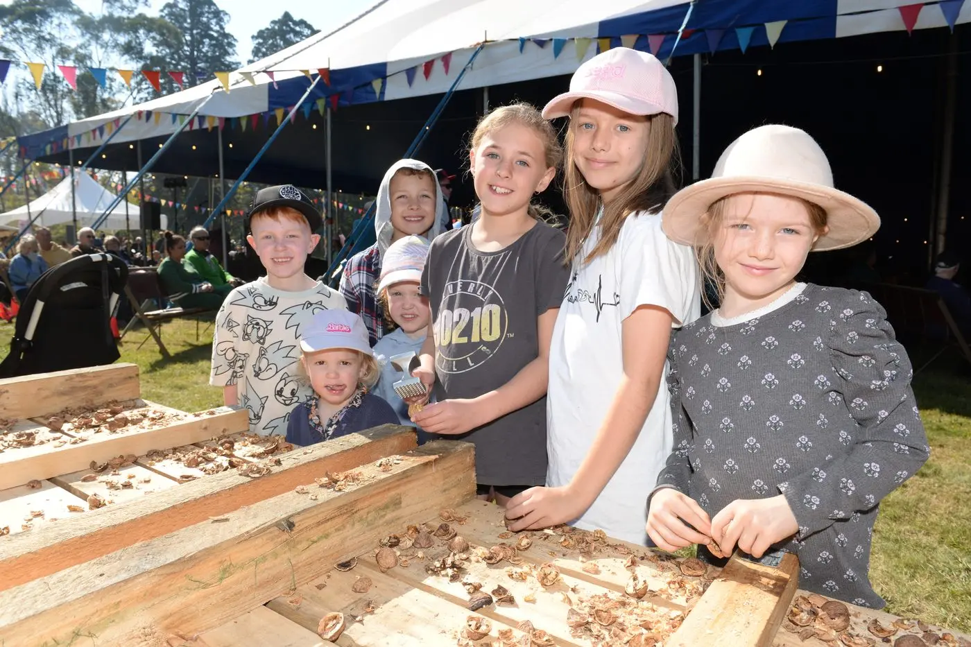 GOING NUTS: (From left) Macedon Ranges residents Leo Baseggio, Daisy Baseggio, Ollie del Mastro and Harriet Baseggio, Ellie Del Mastro, Madison Potter and Lara Potter at the walnut cracking bench. PHOTOS: Brodie Everist 