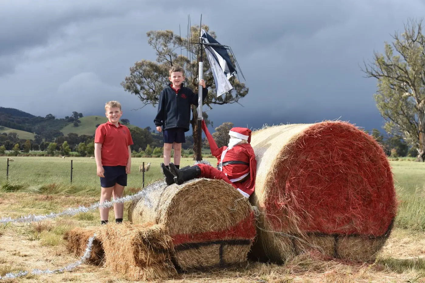 XMAS BALES: Every year, \\'Wolverton\\' at Maindample celebrates the festive season with a different theme, setting up the entrance to the cattle property with decorated haybales. Owner Rachel Parsons said that this year they decided to set\\u2013up the display earlier to add a bit of Christmas cheer to a very wet and overcast Spring. \"We\\'ve had to contend with a bit of damage to the display as a result,\" she said. \"Poor Santa keeps on getting blown down and we have to retrieve him. \"And his umbrella has been broken.\"   Pictured are Oliver and Angus Parsons, who help with the decorating each year. Id:33978